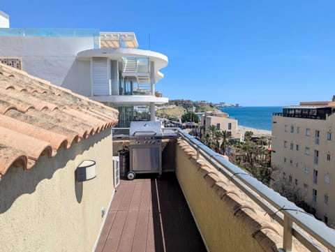 Upper terrace with gas BBQ and a view of the sea